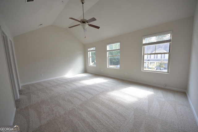 carpeted spare room with lofted ceiling and ceiling fan