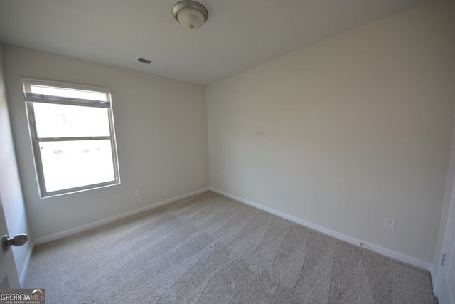 unfurnished room with light colored carpet