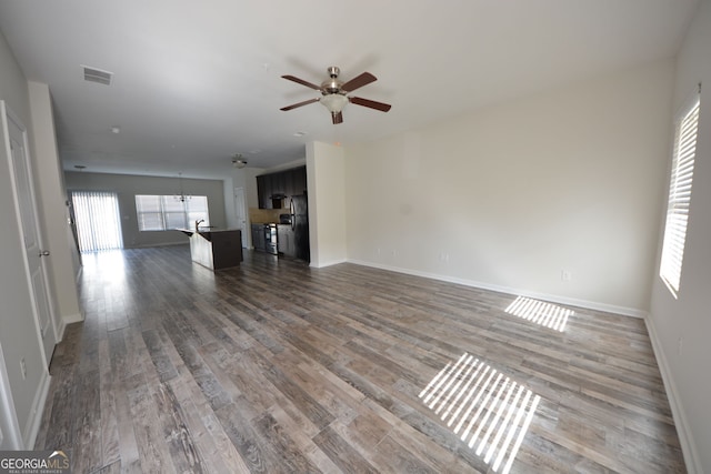 unfurnished living room with hardwood / wood-style floors and ceiling fan