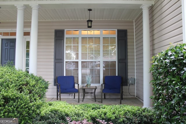 view of exterior entry featuring covered porch