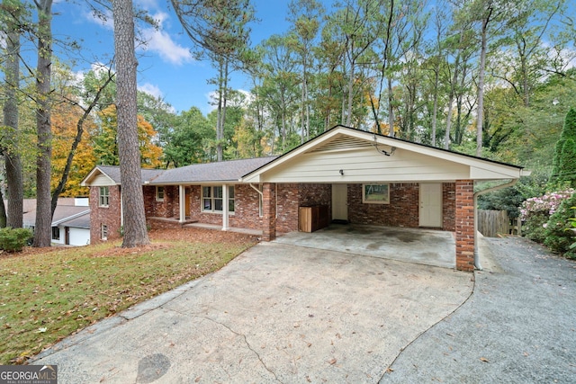 ranch-style home with a front yard and a carport