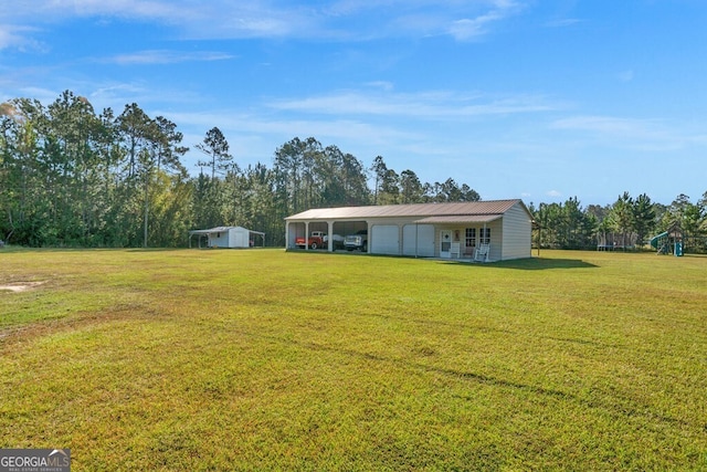 view of yard with an outdoor structure and covered porch