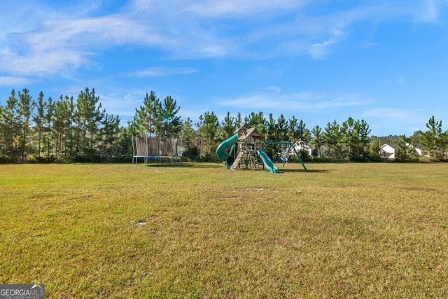 view of yard with a playground and a trampoline