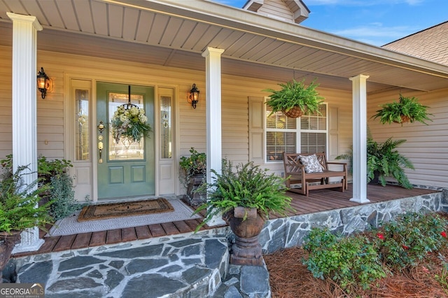 entrance to property featuring a porch