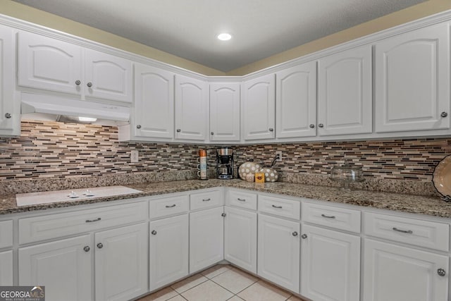 kitchen featuring white cabinets, decorative backsplash, and stone countertops