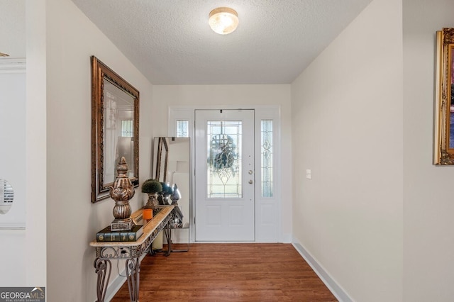 entryway with a textured ceiling and hardwood / wood-style flooring