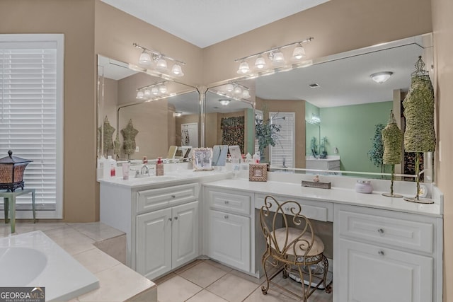 bathroom featuring tile patterned flooring, vanity, and a bath