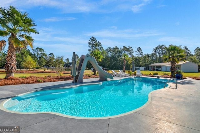 view of pool featuring a patio and a water slide