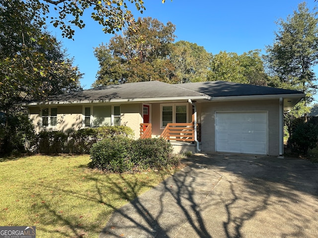 ranch-style home featuring a garage, a front lawn, and covered porch