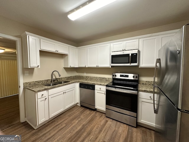 kitchen featuring dark hardwood / wood-style flooring, appliances with stainless steel finishes, sink, and white cabinets