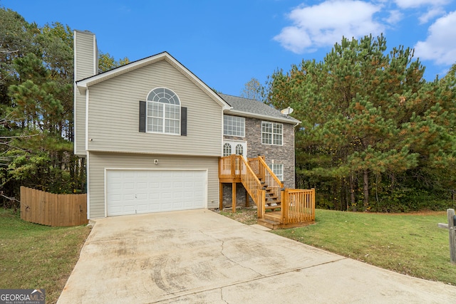 split foyer home featuring a garage and a front lawn