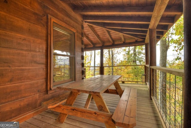 unfurnished sunroom with wood ceiling and beam ceiling