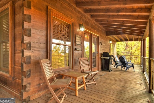 wooden terrace with a porch and grilling area