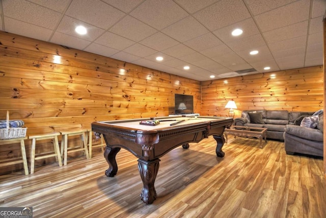 recreation room with hardwood / wood-style floors, wood walls, and billiards