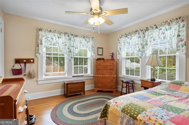 bedroom with light hardwood / wood-style floors and ceiling fan