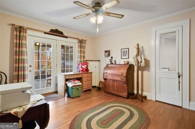 sitting room with ceiling fan, wood-type flooring, and ornamental molding