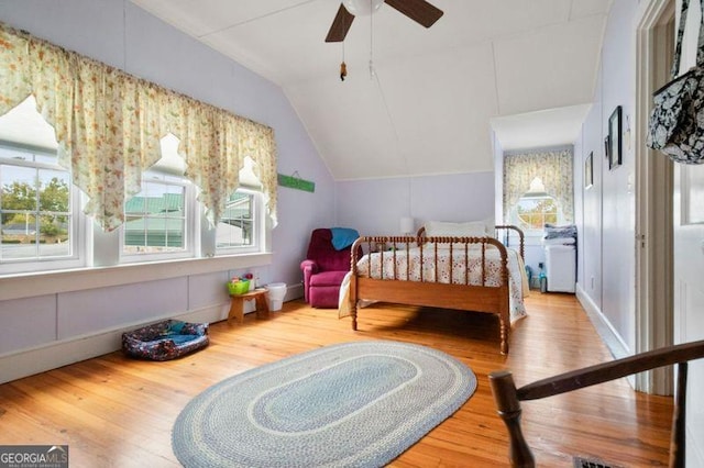 bedroom with lofted ceiling, wood-type flooring, and ceiling fan