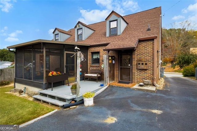 view of front of home with a sunroom