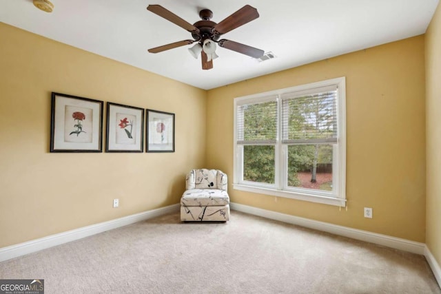 unfurnished room featuring ceiling fan and carpet flooring