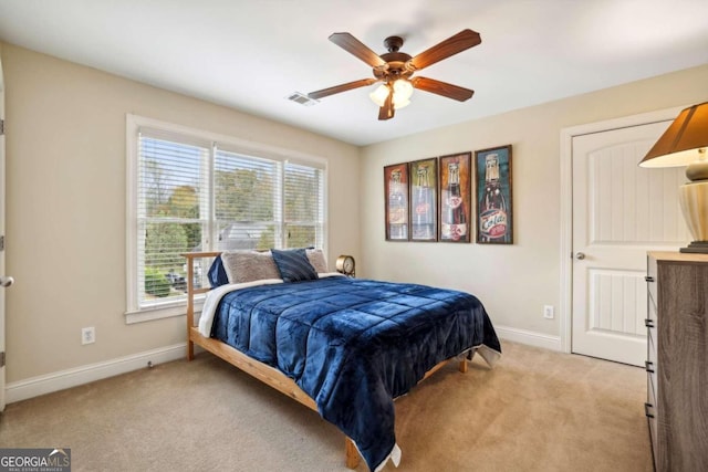 bedroom featuring light colored carpet and ceiling fan