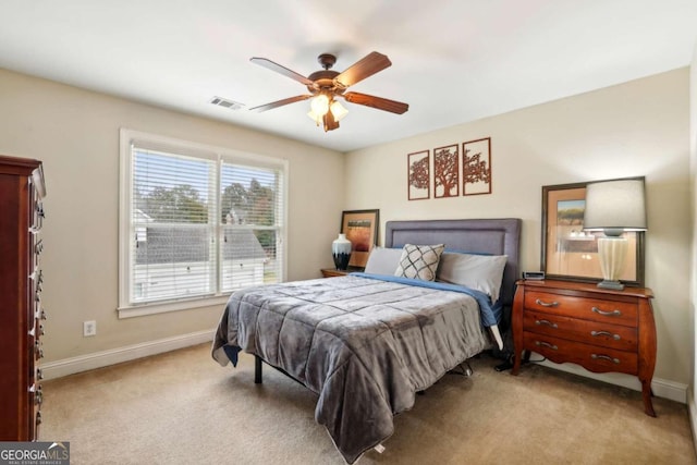 bedroom featuring light carpet and ceiling fan