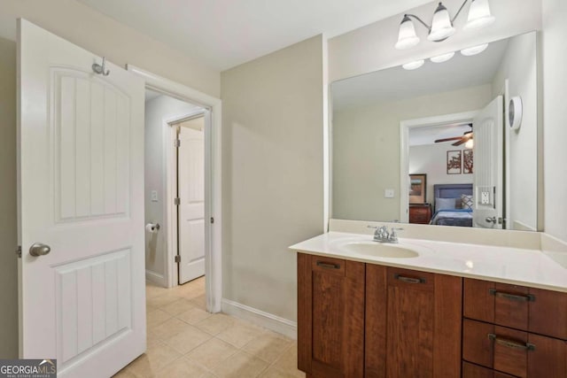 bathroom featuring tile patterned flooring, vanity, and ceiling fan