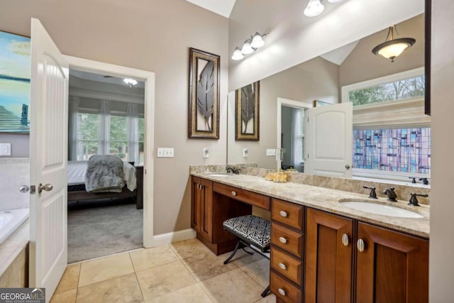 bathroom featuring vanity, lofted ceiling, a bath, and tile patterned floors