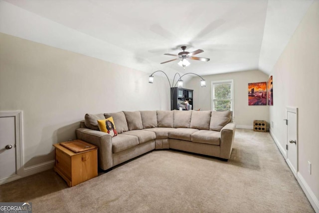 carpeted living room with vaulted ceiling and ceiling fan