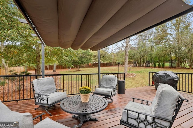 wooden deck with area for grilling and a yard