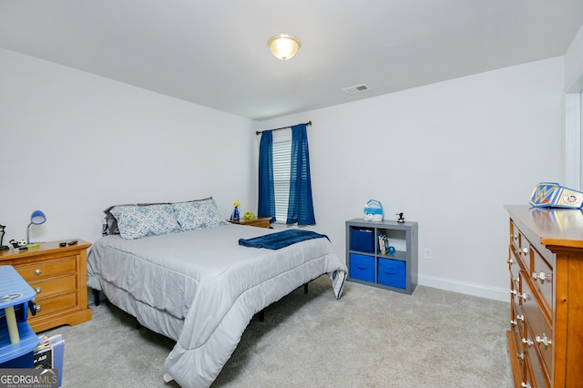 bedroom featuring light colored carpet