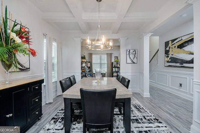 dining space with beam ceiling, light hardwood / wood-style floors, and plenty of natural light