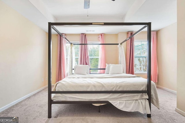 unfurnished bedroom featuring carpet, multiple windows, and ceiling fan