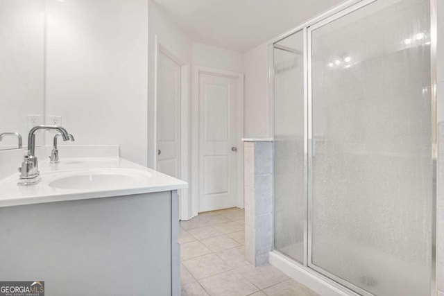 bathroom with vanity, tile patterned floors, and a shower with door