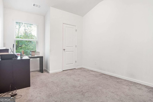 office area with light carpet and vaulted ceiling