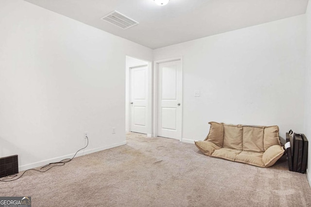 living area featuring light colored carpet