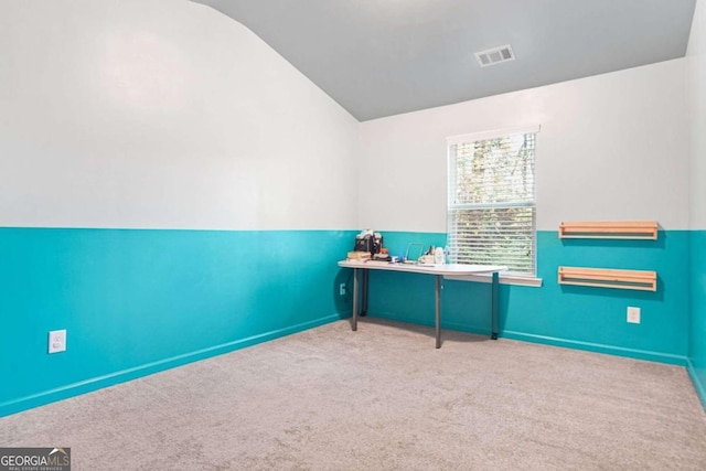 unfurnished office with light colored carpet and lofted ceiling