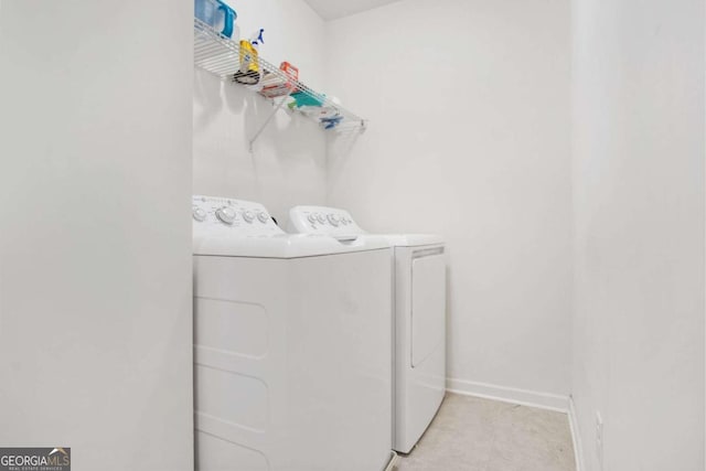 washroom featuring washing machine and clothes dryer