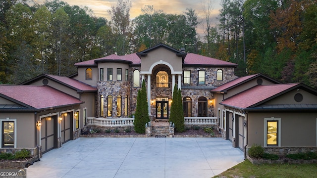 mediterranean / spanish-style home featuring a garage and covered porch