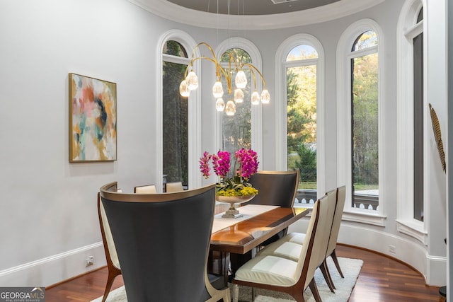 dining room featuring wood-type flooring and ornamental molding