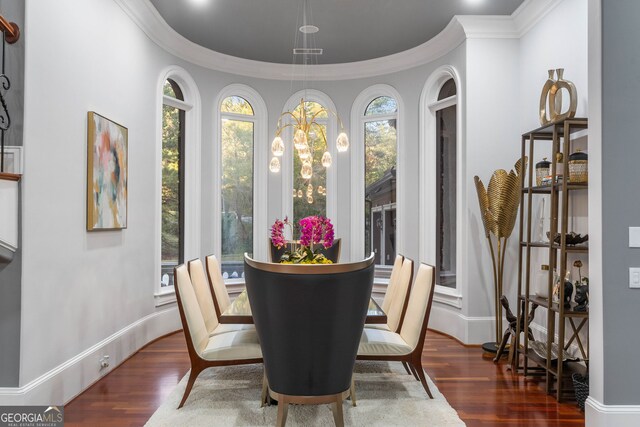 dining room with dark wood-type flooring and crown molding