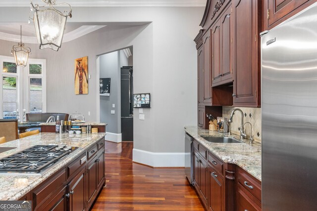 kitchen with stainless steel appliances, sink, tasteful backsplash, ornamental molding, and dark hardwood / wood-style floors