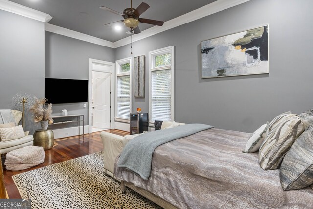 bedroom featuring wood-type flooring, ceiling fan, and crown molding