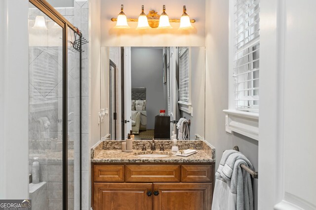 bathroom with a shower with door and vanity