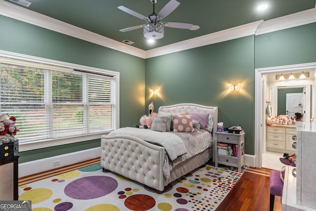 bedroom featuring hardwood / wood-style flooring, ceiling fan, connected bathroom, and crown molding