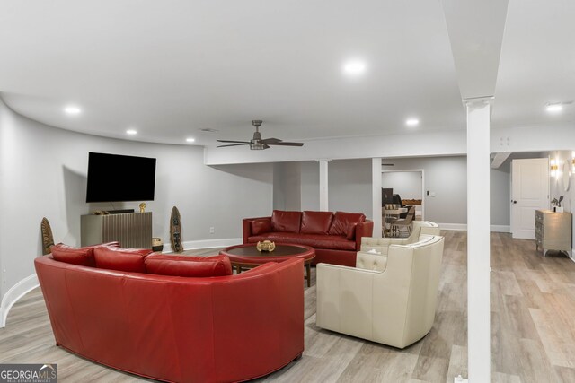 living room with ceiling fan and light hardwood / wood-style floors