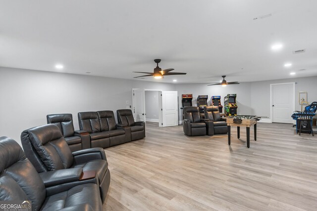 living room with ceiling fan and light hardwood / wood-style floors