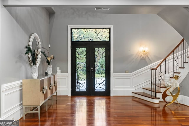 entryway featuring french doors, hardwood / wood-style flooring, and a healthy amount of sunlight