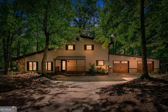 view of property with a garage and covered porch