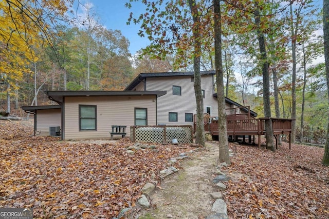 back of property featuring central AC and a deck