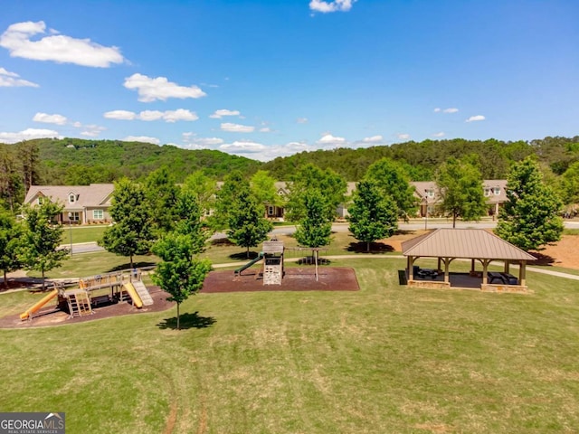 exterior space featuring a playground, a lawn, and a gazebo